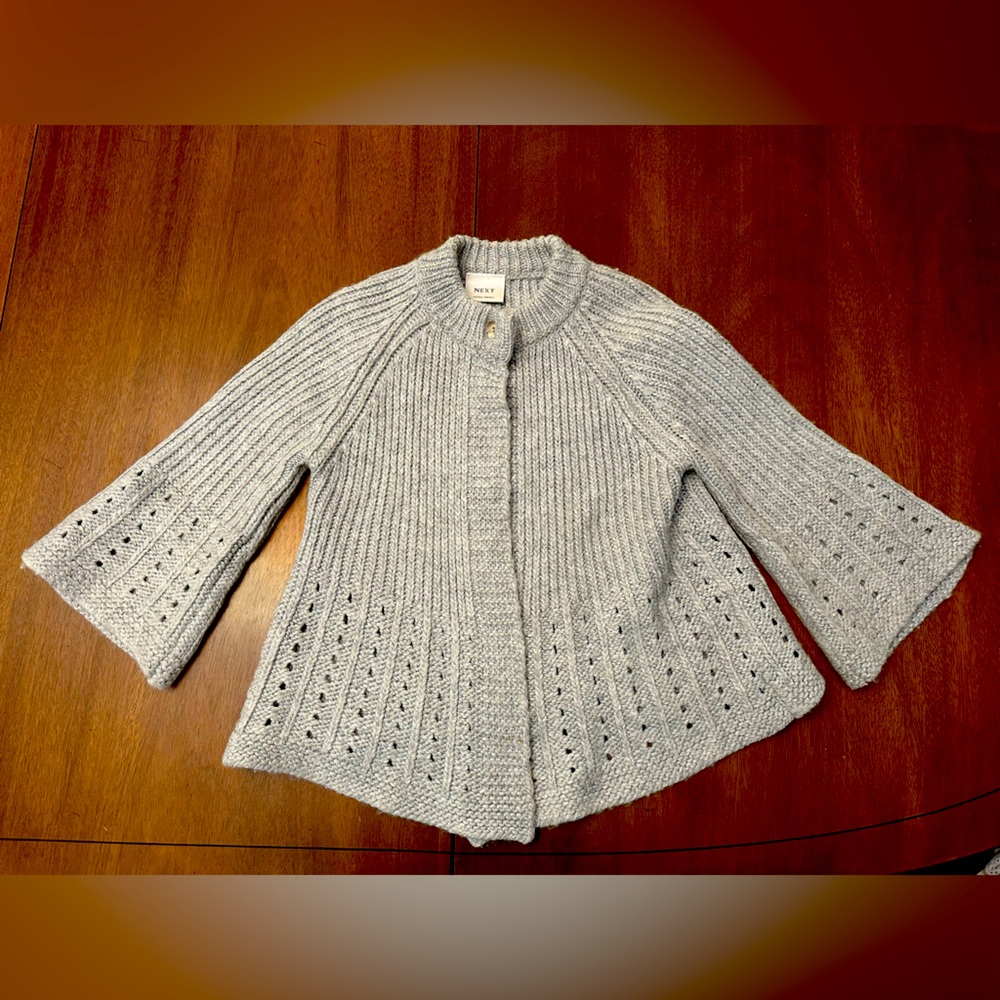 Cutest XS sweater. Gray. Buttons. Flares at bottom. Smells good/Clean. Brand new